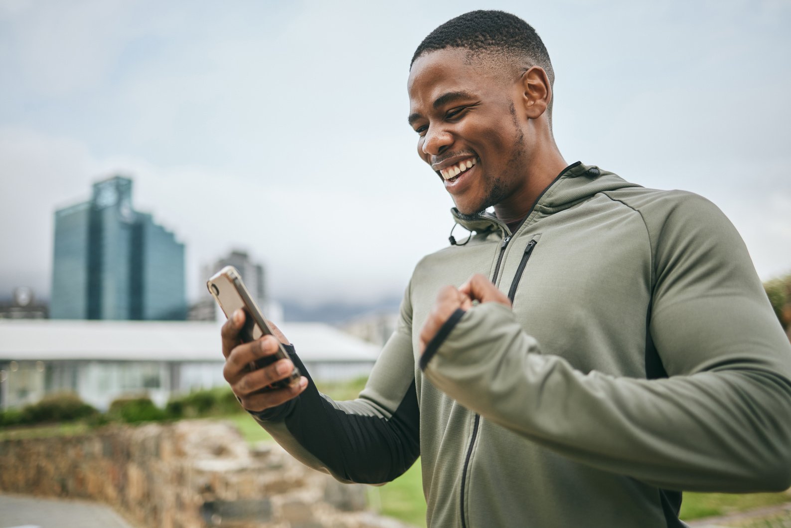 Man Achieving a Fitness Milestone on a Phone App 